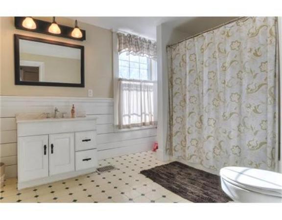 117 South Main Street Middleboro, MA 02346 - Photo 21 of 30 a bathroom with a granite countertop sink a toilet a mirror and shower curtain