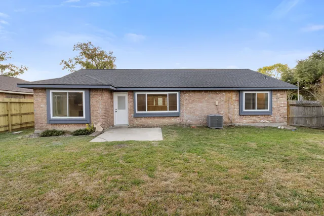 a backyard of a house with table and chairs