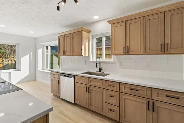 a kitchen with sink and cabinets