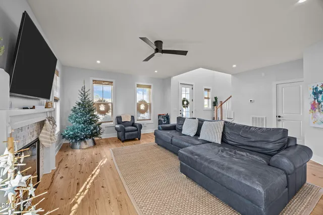 a living room with furniture and kitchen view