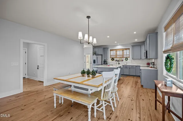 a kitchen with cabinets stainless steel appliances a sink and a window