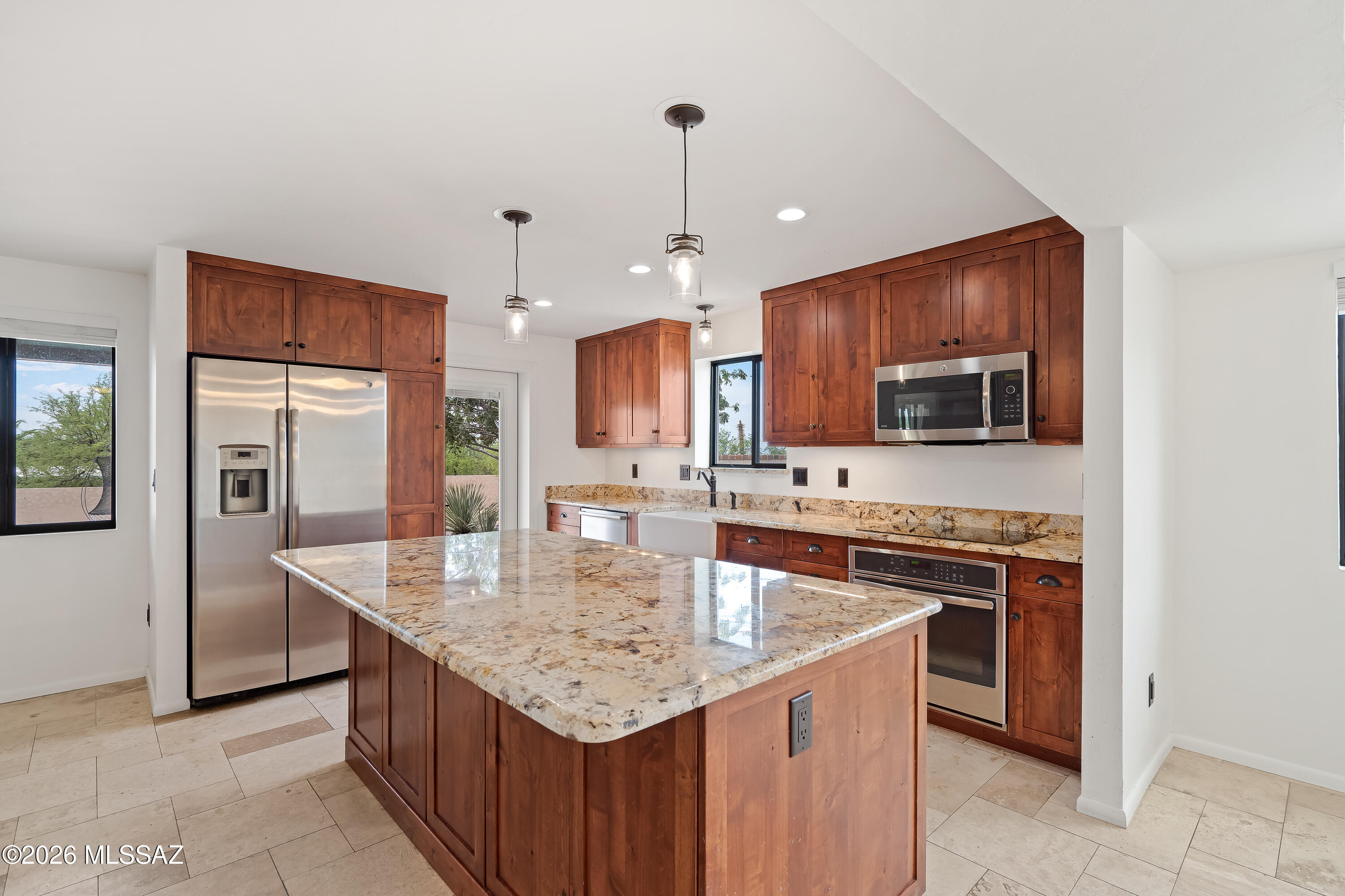 9420 East Ravine Trail Tucson, AZ 85749 - Photo 12 of 39 a kitchen with stainless steel appliances granite countertop a sink stove and refrigerator