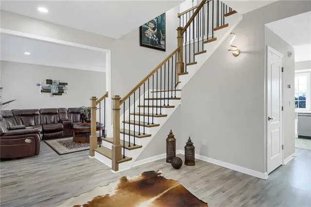 a view of entryway and hall with wooden floor