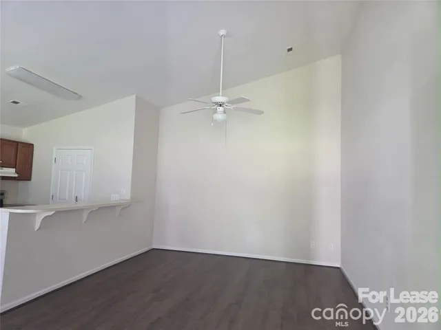 a view of a room with wooden floor and white walls