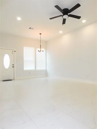 a view of a room with a window and wooden floor