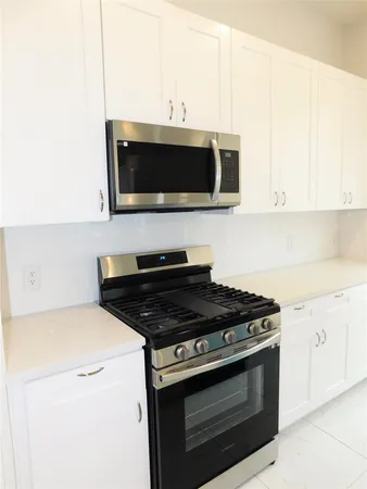 a kitchen with a stove and a microwave