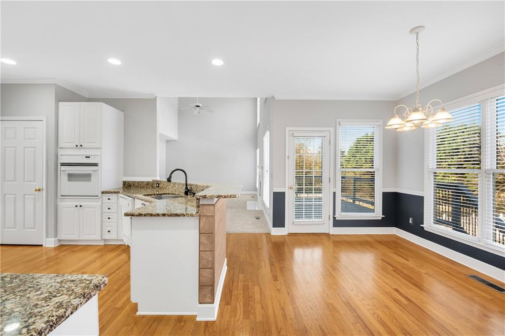161 Brook Lane Roswell, GA 30075 - Photo 11 of 66 a kitchen with stainless steel appliances granite countertop a stove and a wooden floors