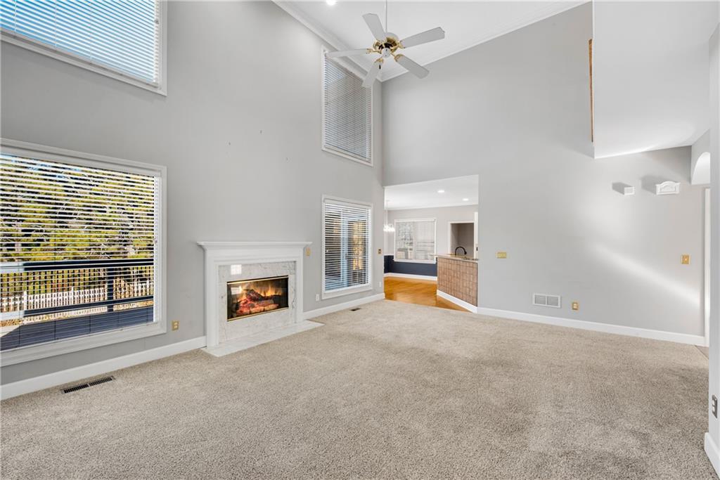 161 Brook Lane Roswell, GA 30075 - Photo 17 of 66 an empty room with fireplace fan and windows