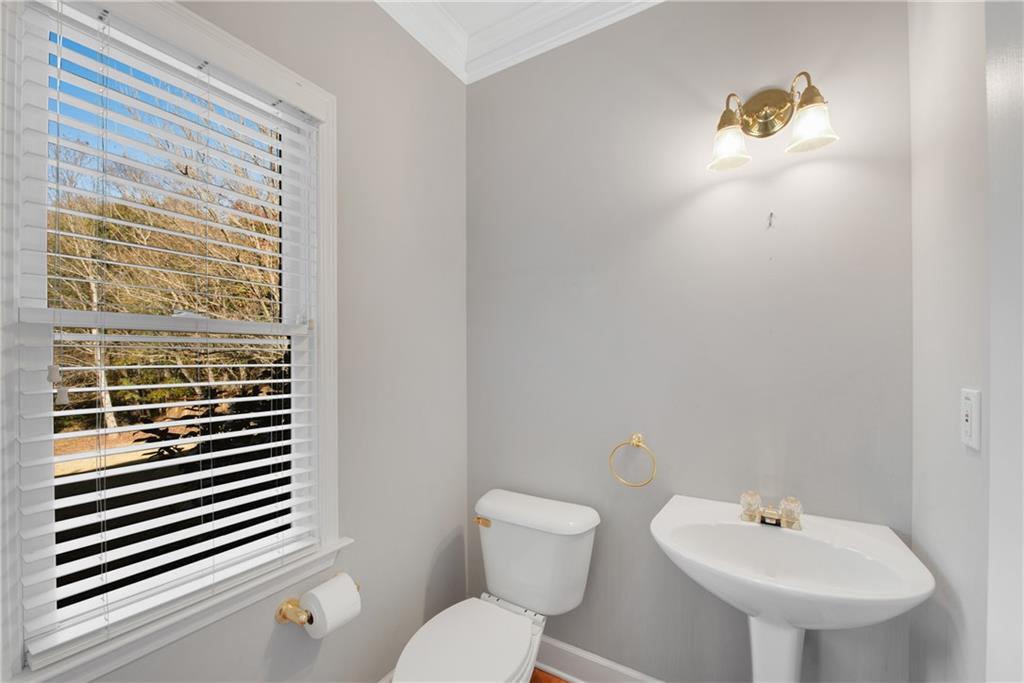 161 Brook Lane Roswell, GA 30075 - Photo 19 of 66 a bathroom with a sink a toilet and a mirror