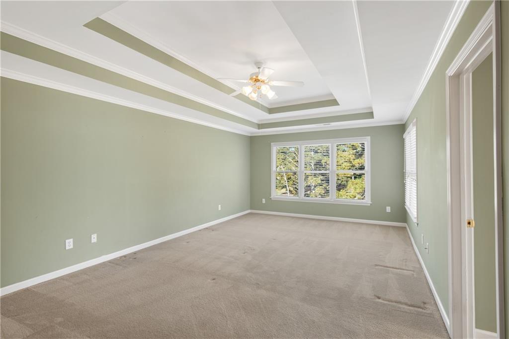 161 Brook Lane Roswell, GA 30075 - Photo 25 of 66 en empty room with windows and ceiling fan