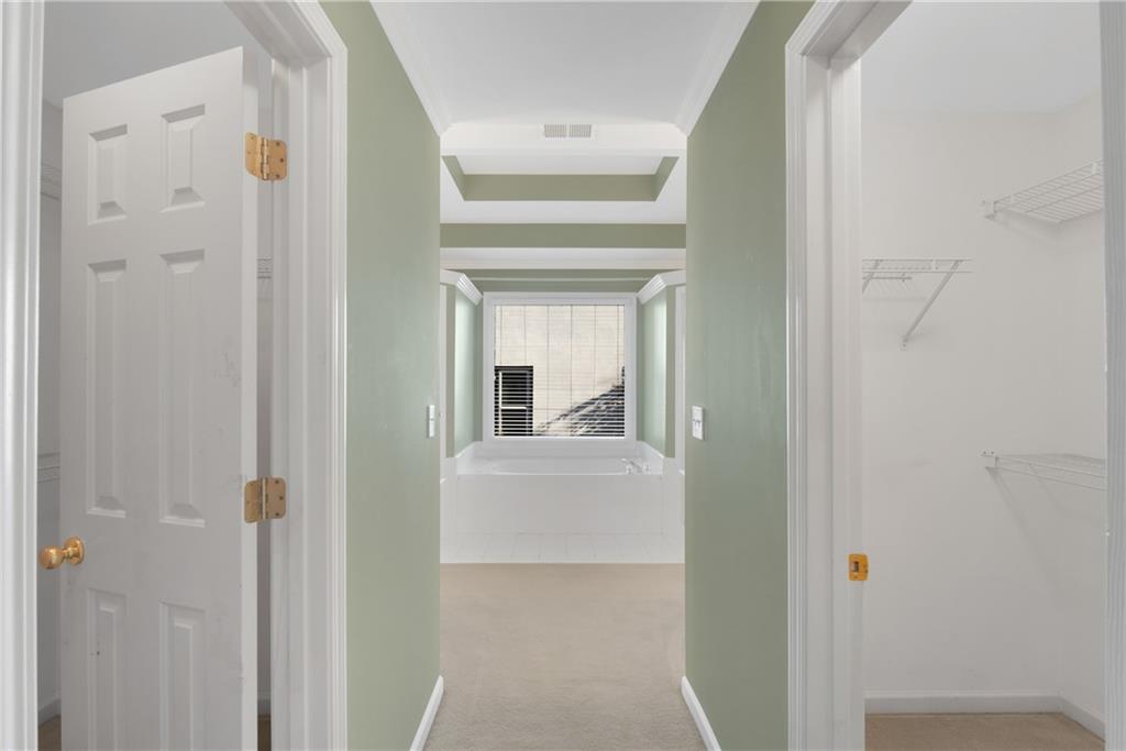 161 Brook Lane Roswell, GA 30075 - Photo 28 of 66 a view of a hallway with white cabinets and a refrigerator