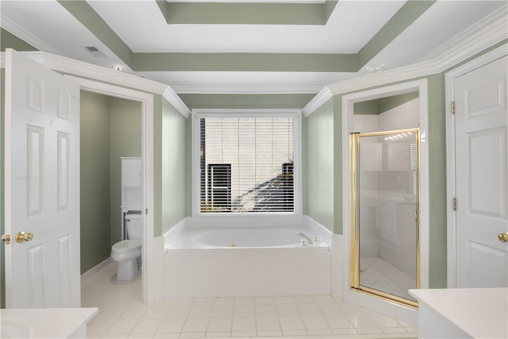 161 Brook Lane Roswell, GA 30075 - Photo 31 of 66 a spacious bathroom with a bathtub and shower