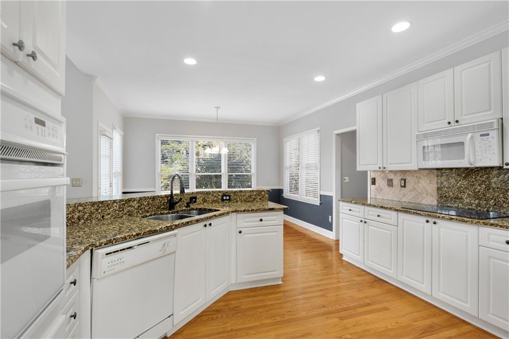 161 Brook Lane Roswell, GA 30075 - Photo 7 of 66 a kitchen with granite countertop a sink and cabinets