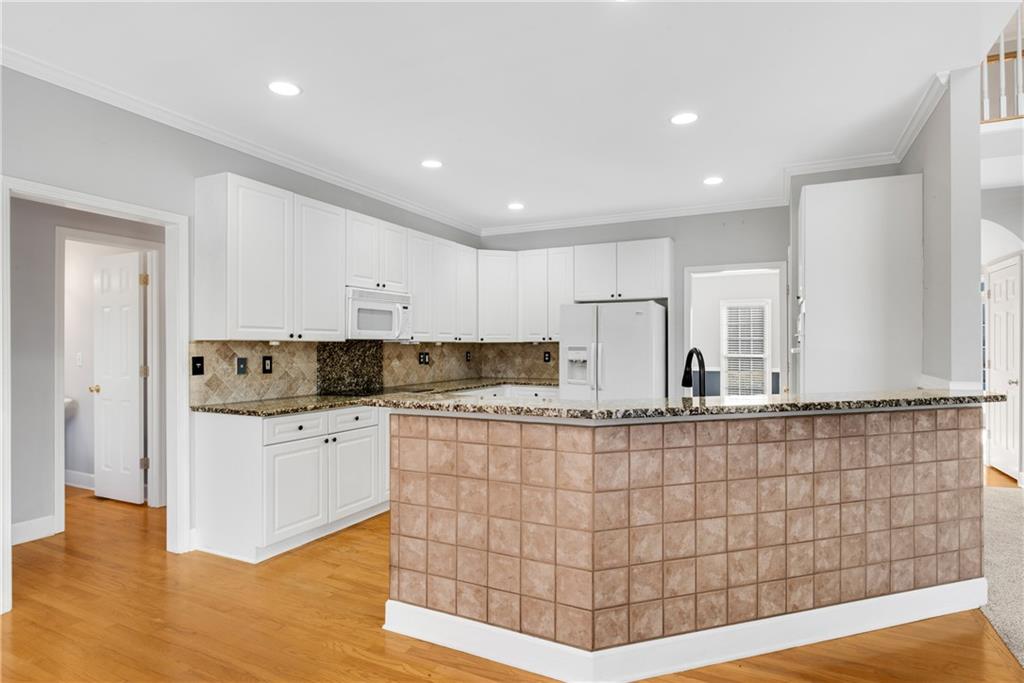 161 Brook Lane Roswell, GA 30075 - Photo 9 of 66 a kitchen with stainless steel appliances kitchen island granite countertop a refrigerator and a stove top oven