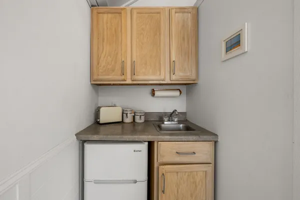 a view of a storage and utility room with granite countertop cabinets