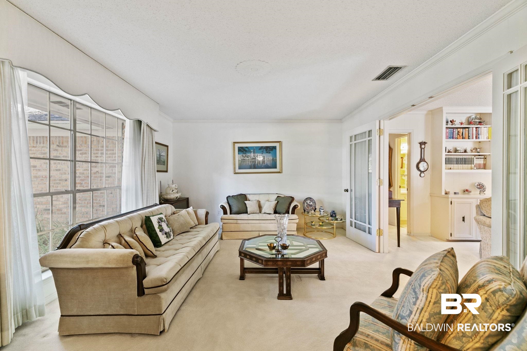 752 Evergreen Street Fairhope, AL 36532 - Photo 20 of 100 Carpeted living room with a textured ceiling and ornamental molding
