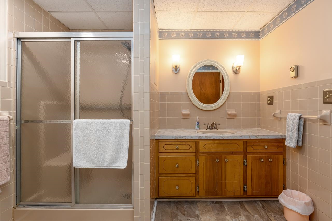 916 Union Church Road Churchville, VA 24421 - Photo 29 of 74 a bathroom with a granite countertop sink a mirror and a shower