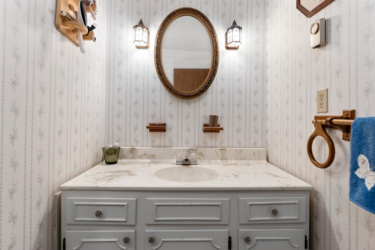 916 Union Church Road Churchville, VA 24421 - Photo 38 of 74 a bathroom with a granite countertop sink and a mirror