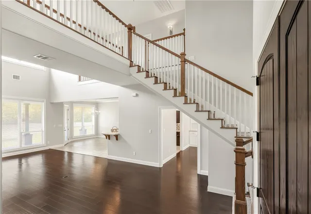 a view of entryway and hall with wooden floor