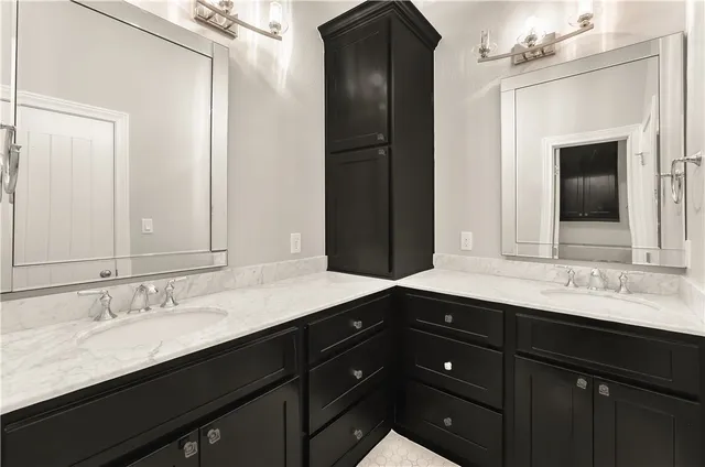 a bathroom with a sink double vanity and a mirror