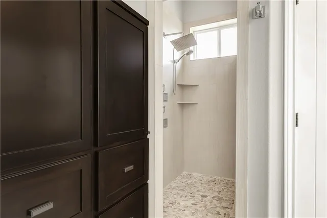 a bathroom with a shower and a glass door