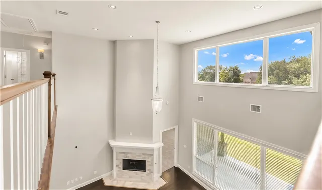 a view of a hallway with wooden floor and entryway