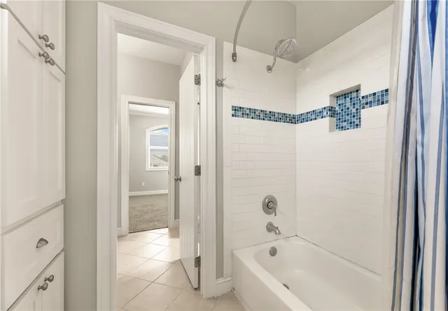 a bathroom with a bathtub and shower