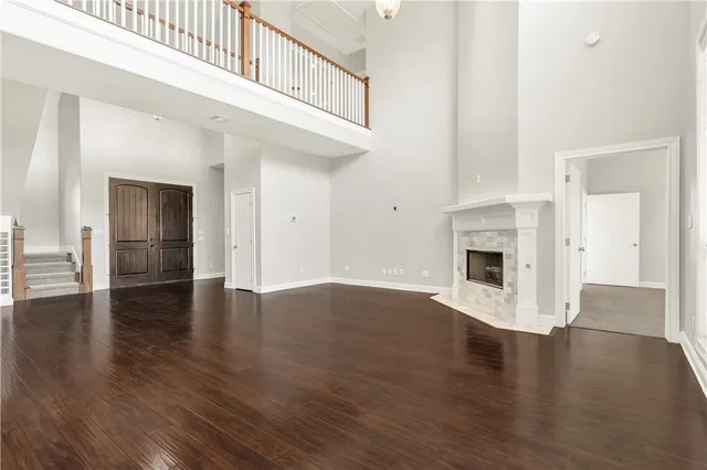 a view of empty room with wooden floor and fireplace