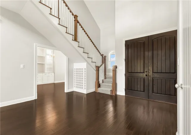 a view of entryway with wooden floor and stairs