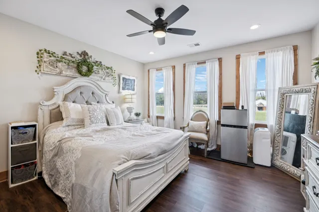 a view of a pathway both side of grassy field with shrub