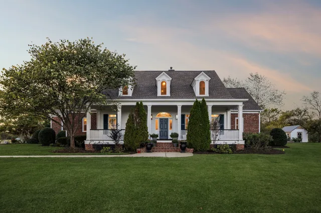 a view of a dining room with furniture and a chandelier
