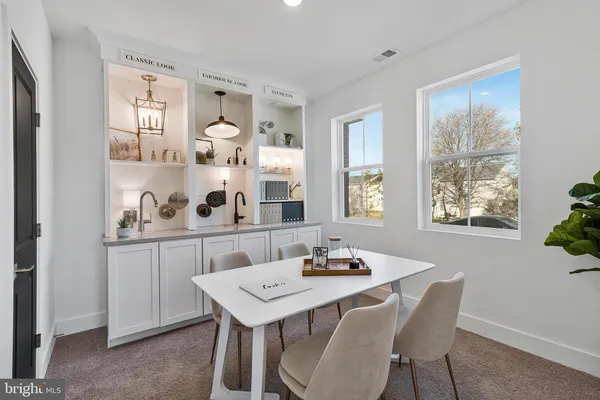 a kitchen with stainless steel appliances kitchen island granite countertop a stove a sink a refrigerator and a dining table with wooden floor
