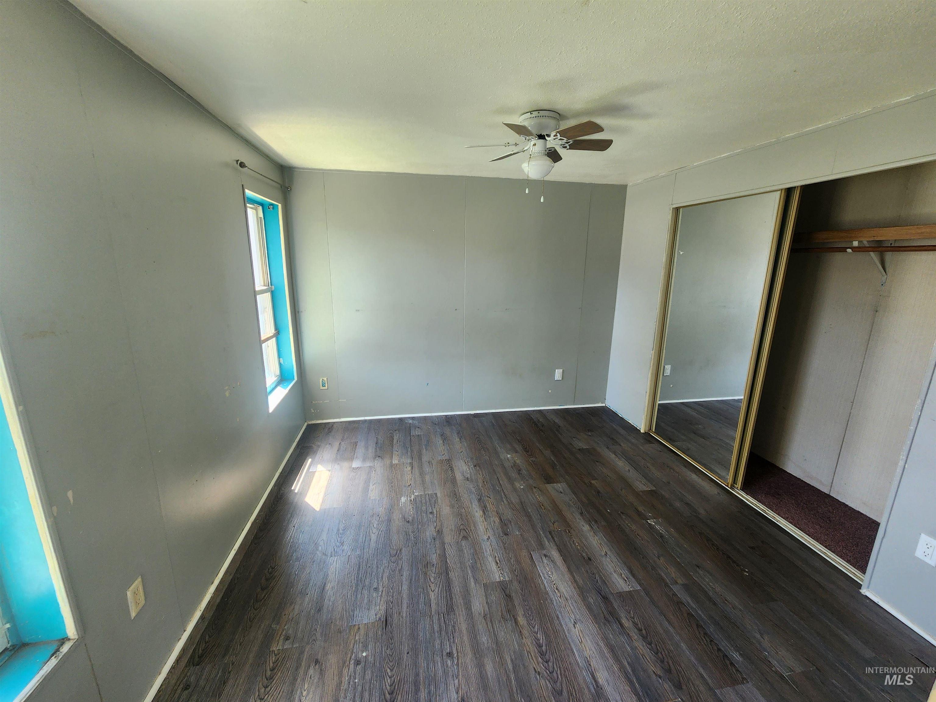 616 North Kings Road Nampa, ID 83687 - Photo 7 of 12 Spacious interior featuring wood-finish flooring, a ceiling fan, and mirrored closet doors