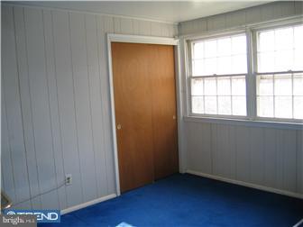 505 Scott Road Oreland, PA 19075 - Photo 9 of 10 an empty room with wooden floor and windows