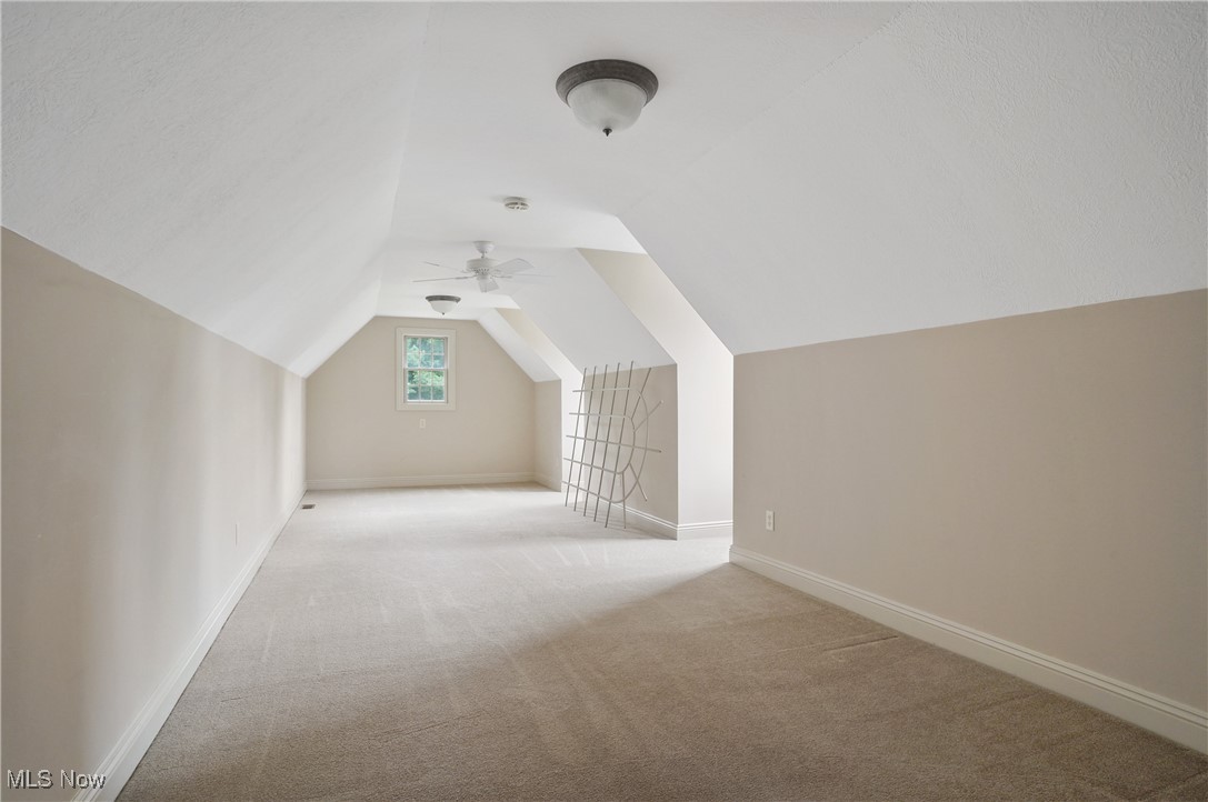 5952 Beach Road Wadsworth, OH 44281 - Photo 27 of 40 Bonus room with light colored carpet, lofted ceiling, and ceiling fan