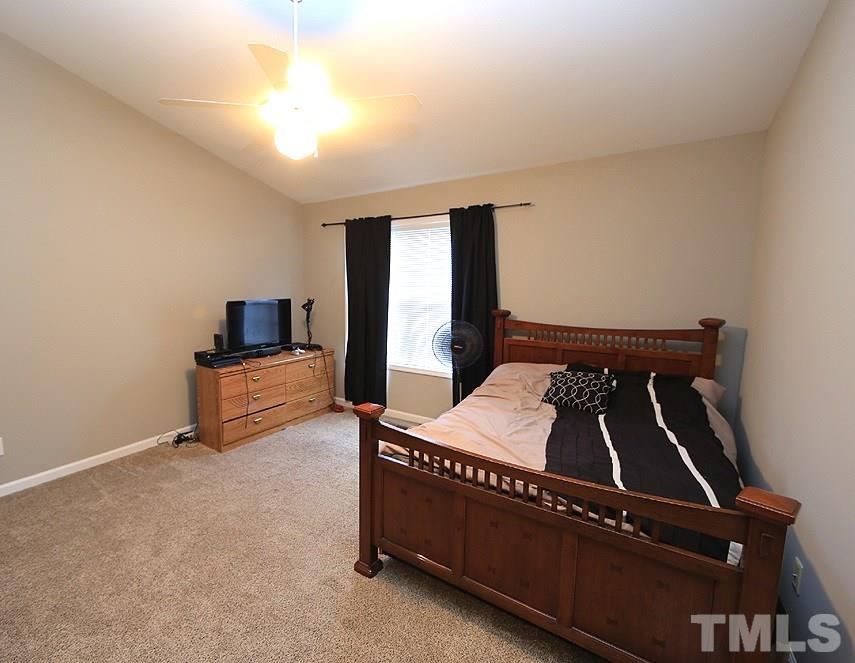 2011 Rivergate Road, Unit 101 Raleigh, NC 27614 - Photo 8 of 12 a bed room with a bed and a tv