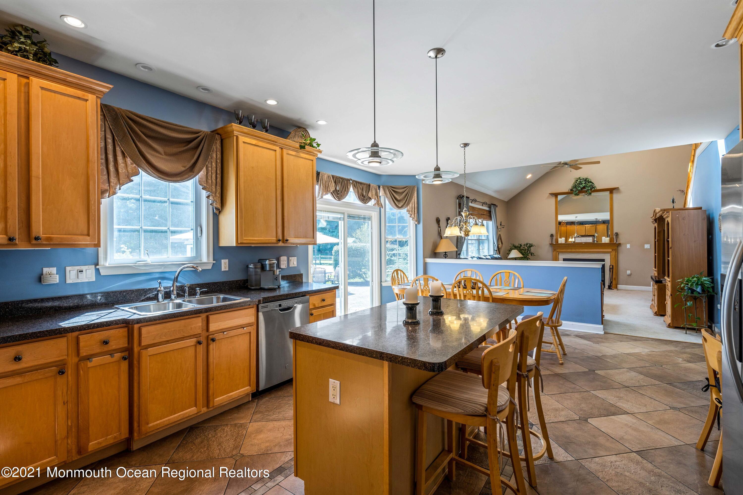 5 Michael Drive Cream Ridge, NJ 08514 - Photo 16 of 69 a kitchen with stainless steel appliances granite countertop a sink a stove a dining table and chairs