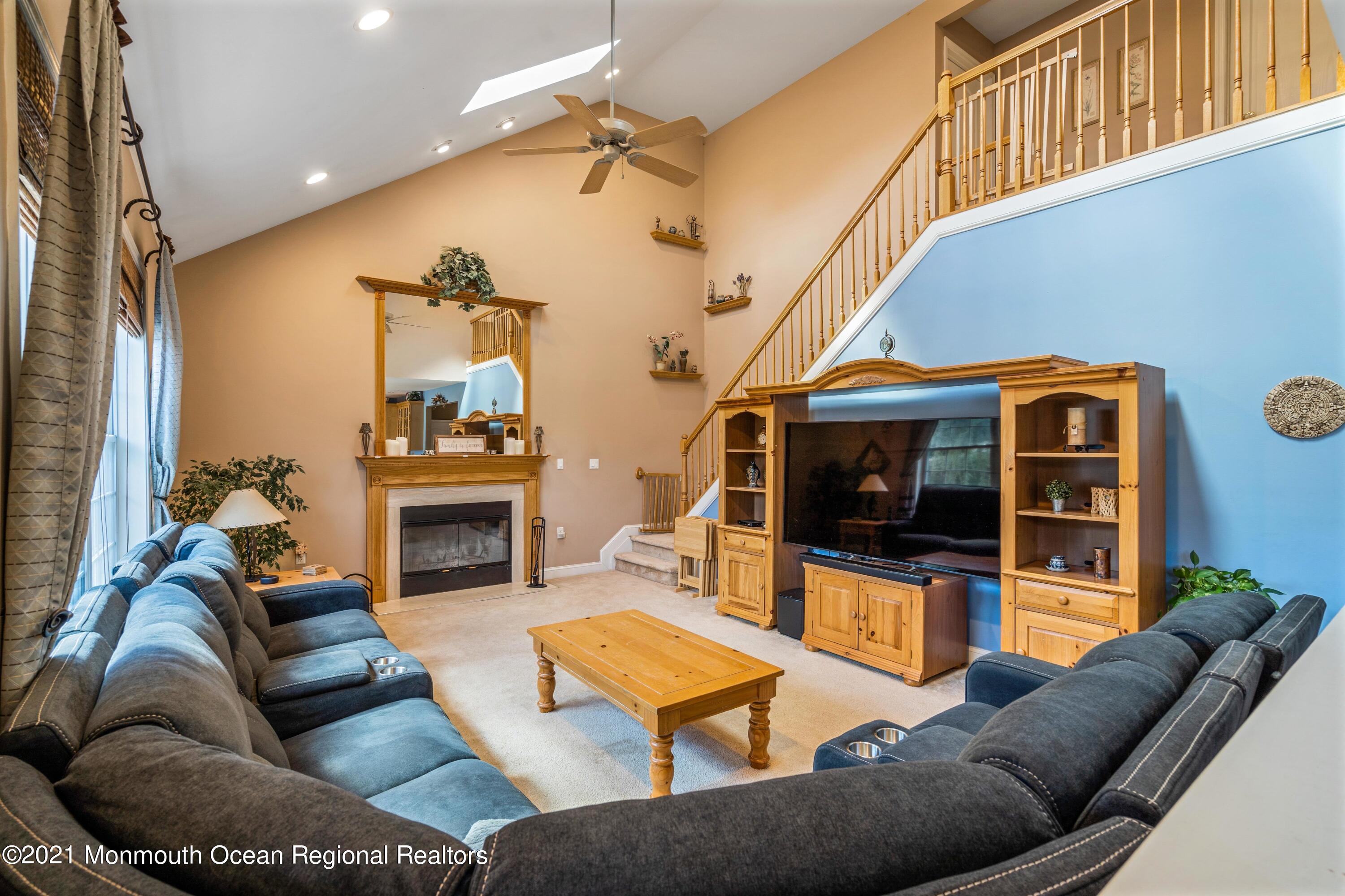 5 Michael Drive Cream Ridge, NJ 08514 - Photo 24 of 69 a living room with furniture a fireplace and a flat screen tv
