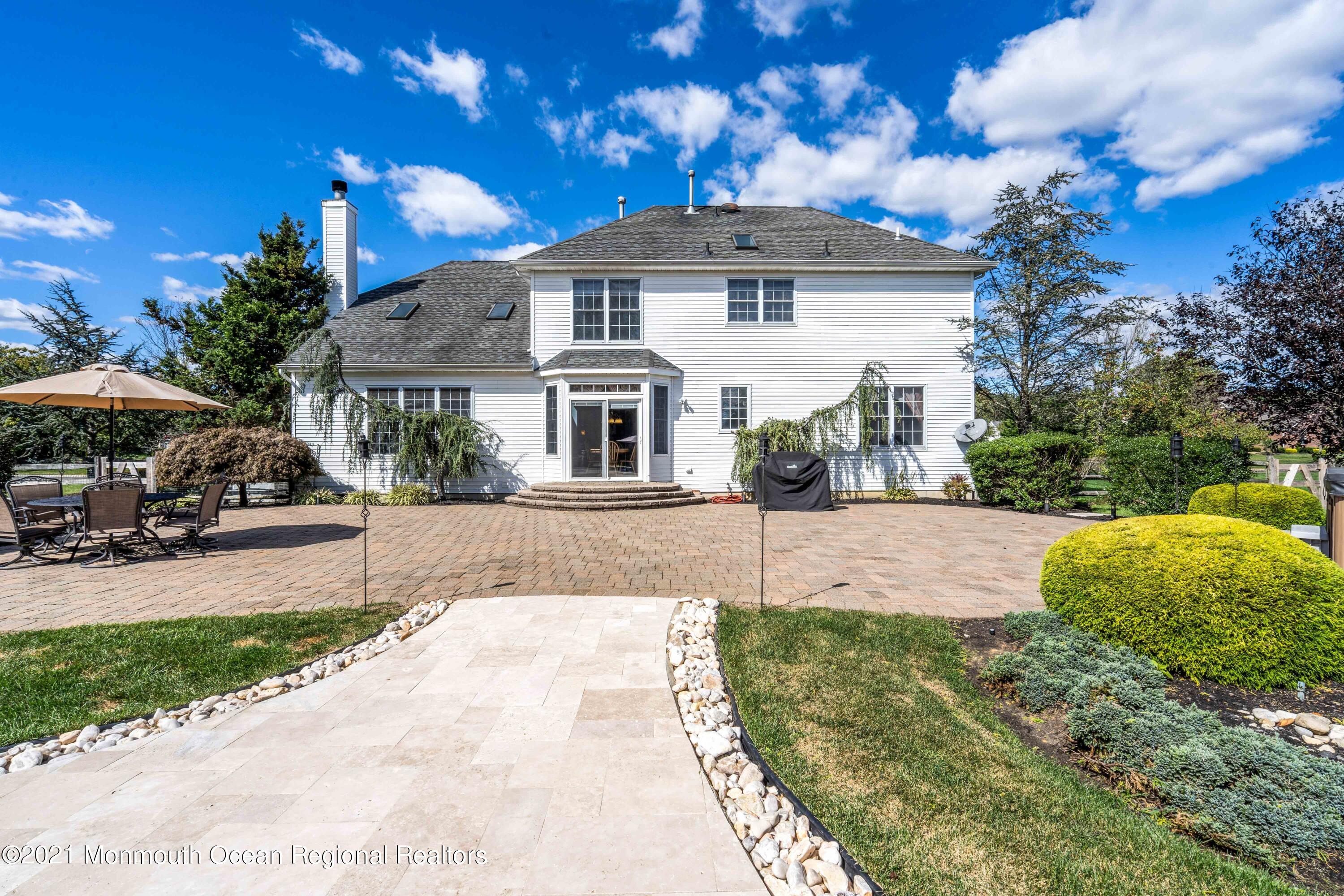 5 Michael Drive Cream Ridge, NJ 08514 - Photo 45 of 69 a front view of a house with a yard and potted plants