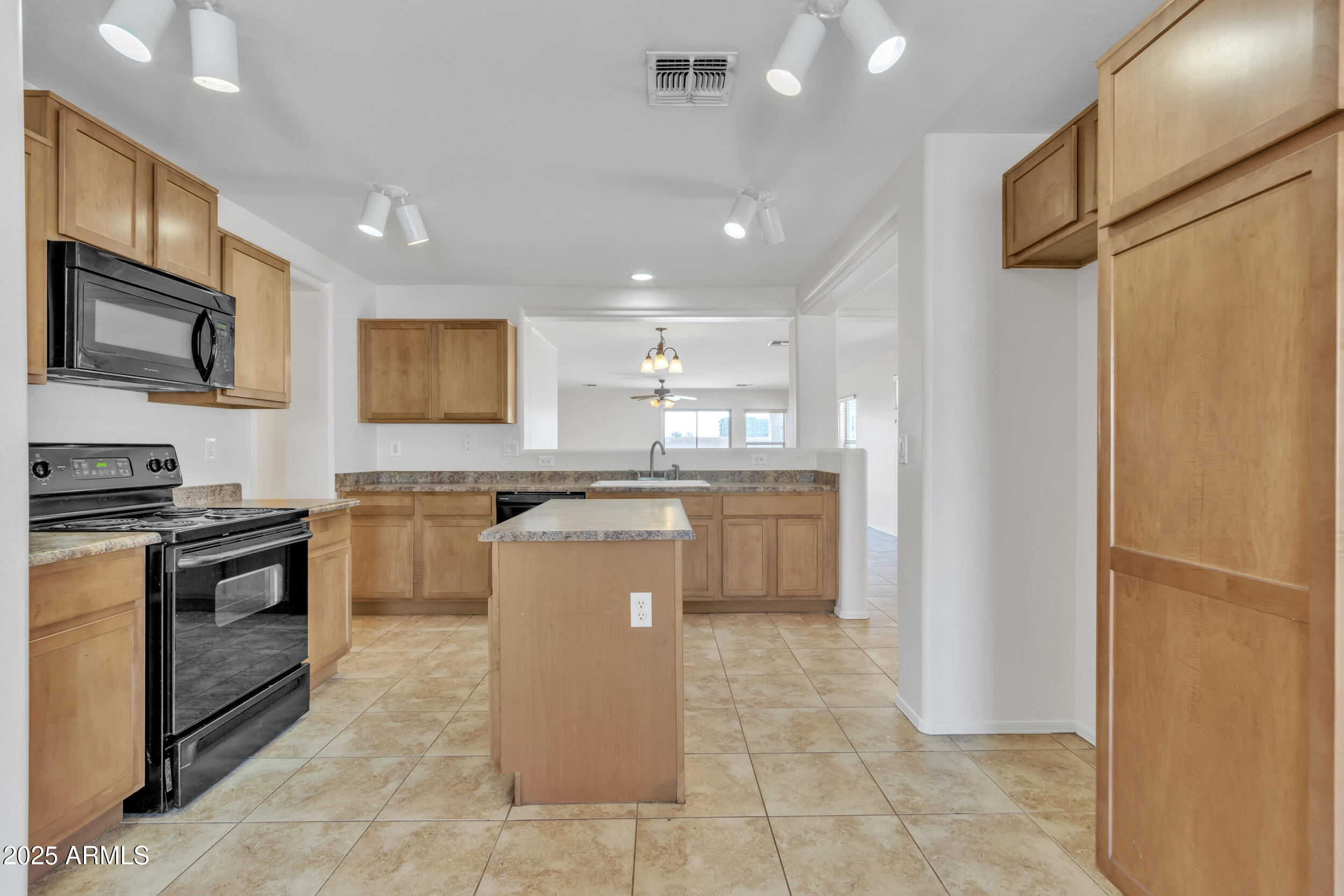 43849 West Cowpath Road Maricopa, AZ 85138 - Photo 11 of 42 a kitchen with a refrigerator a stove top oven and a sink