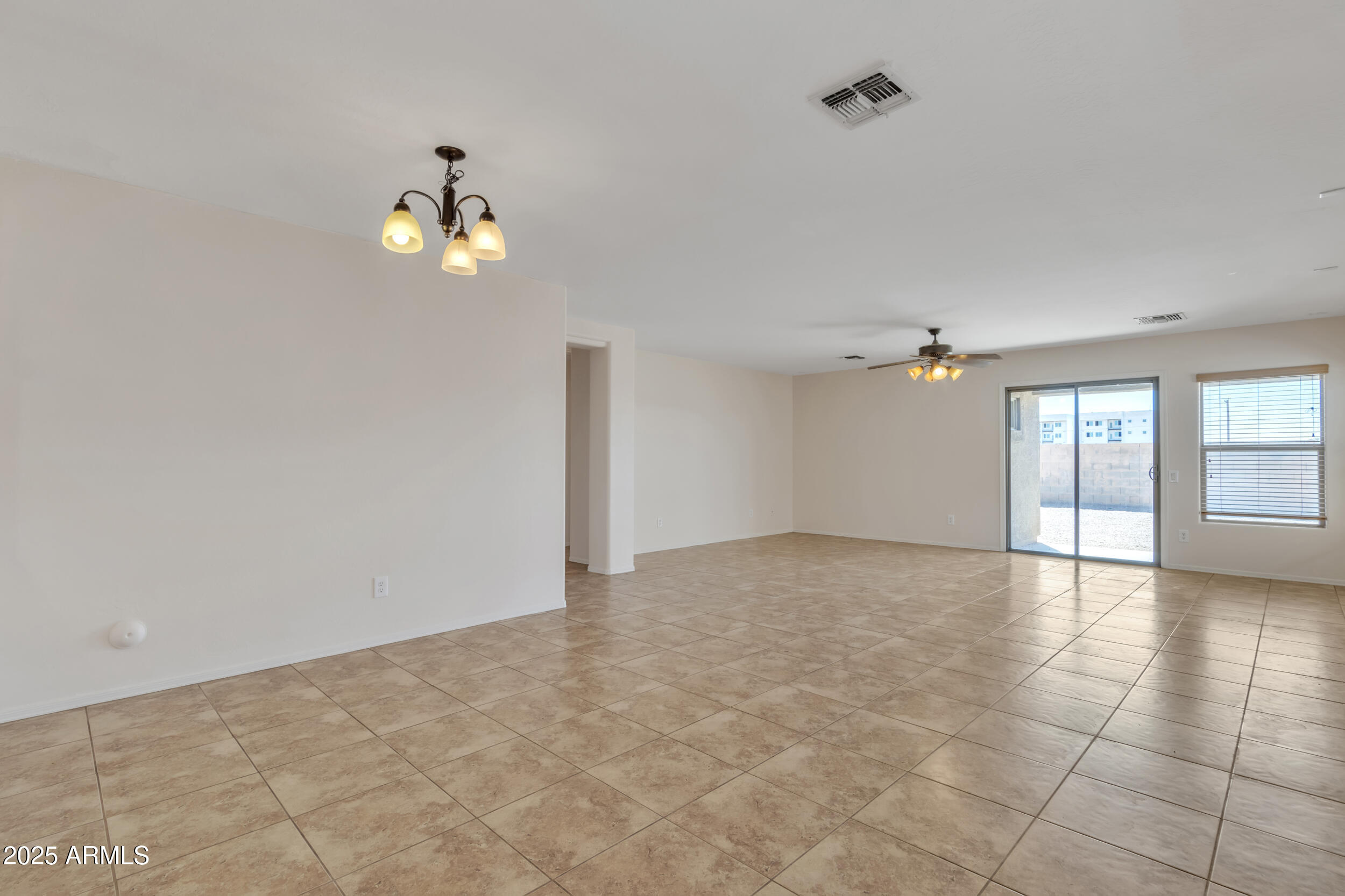 43849 West Cowpath Road Maricopa, AZ 85138 - Photo 19 of 42 wooden floor in an empty room with a window