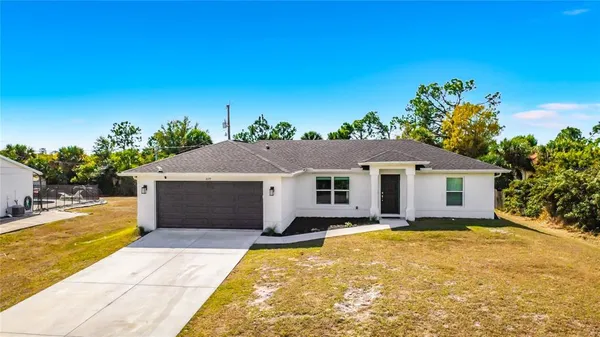 a view of a house with a backyard