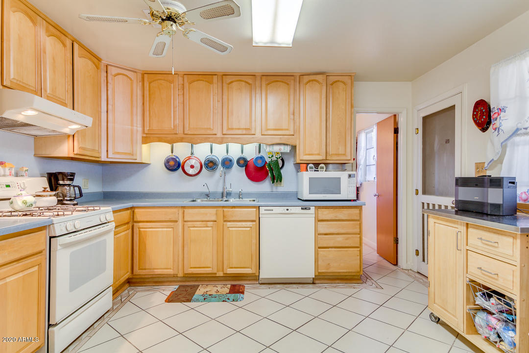 3320 West Ocotillo Road Phoenix, AZ 85017 - Photo 11 of 35 a kitchen with stainless steel appliances granite countertop a refrigerator and sink