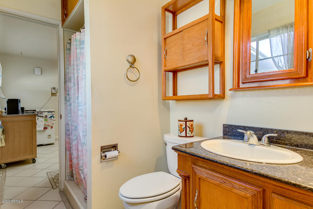 3320 West Ocotillo Road Phoenix, AZ 85017 - Photo 17 of 35 a bathroom with a granite countertop sink mirror vanity and a toilet