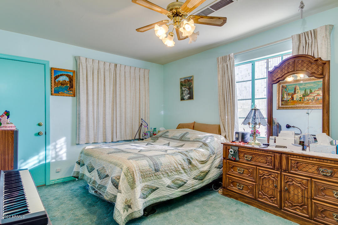 3320 West Ocotillo Road Phoenix, AZ 85017 - Photo 19 of 35 a bedroom with a bed and a chandelier