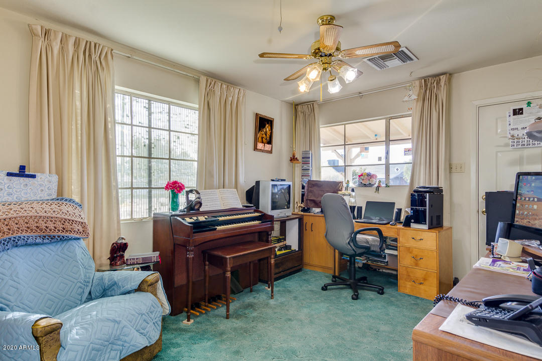 3320 West Ocotillo Road Phoenix, AZ 85017 - Photo 21 of 35 a work room with furniture and a chandelier fan