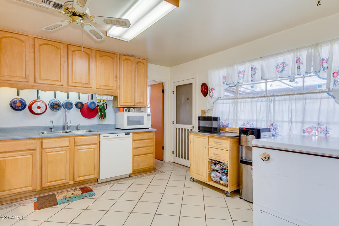 3320 West Ocotillo Road Phoenix, AZ 85017 - Photo 10 of 35 a kitchen with stainless steel appliances granite countertop a sink and cabinets
