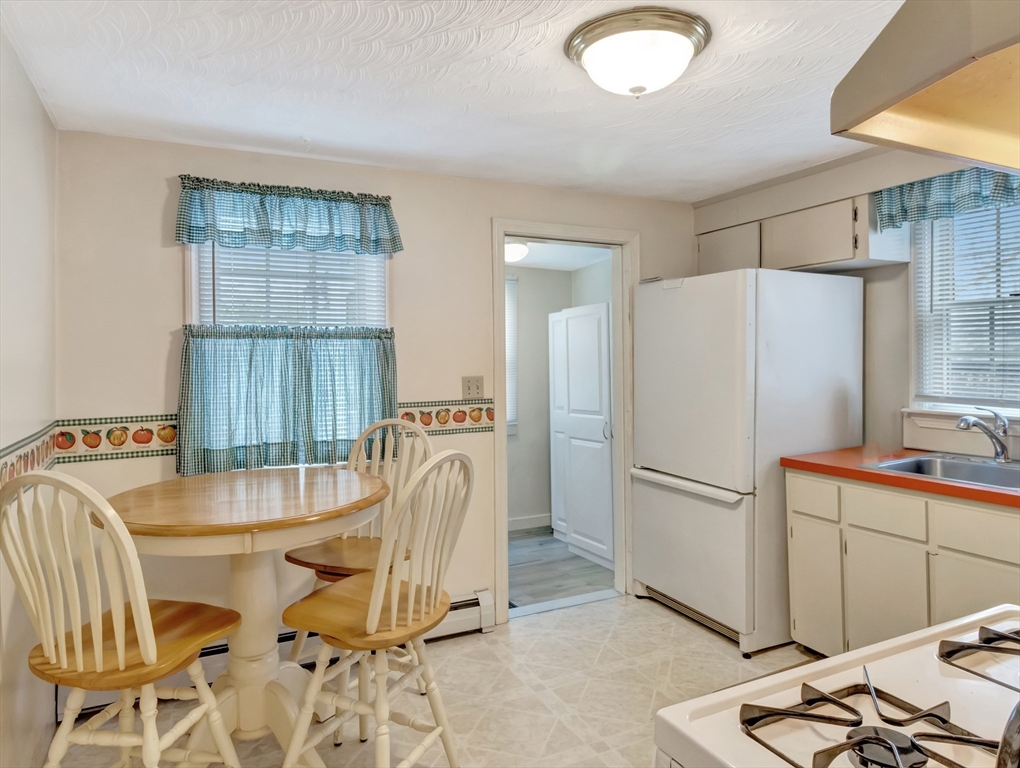 5 G Street Hull, MA 02045 - Photo 18 of 41 a kitchen with a refrigerator a sink and cabinets