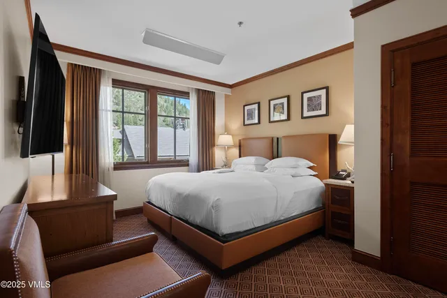 a bedroom with a large bed and a window