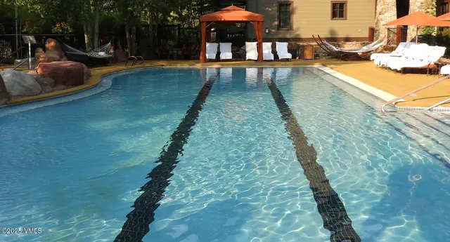 a swimming pool view with a garden space